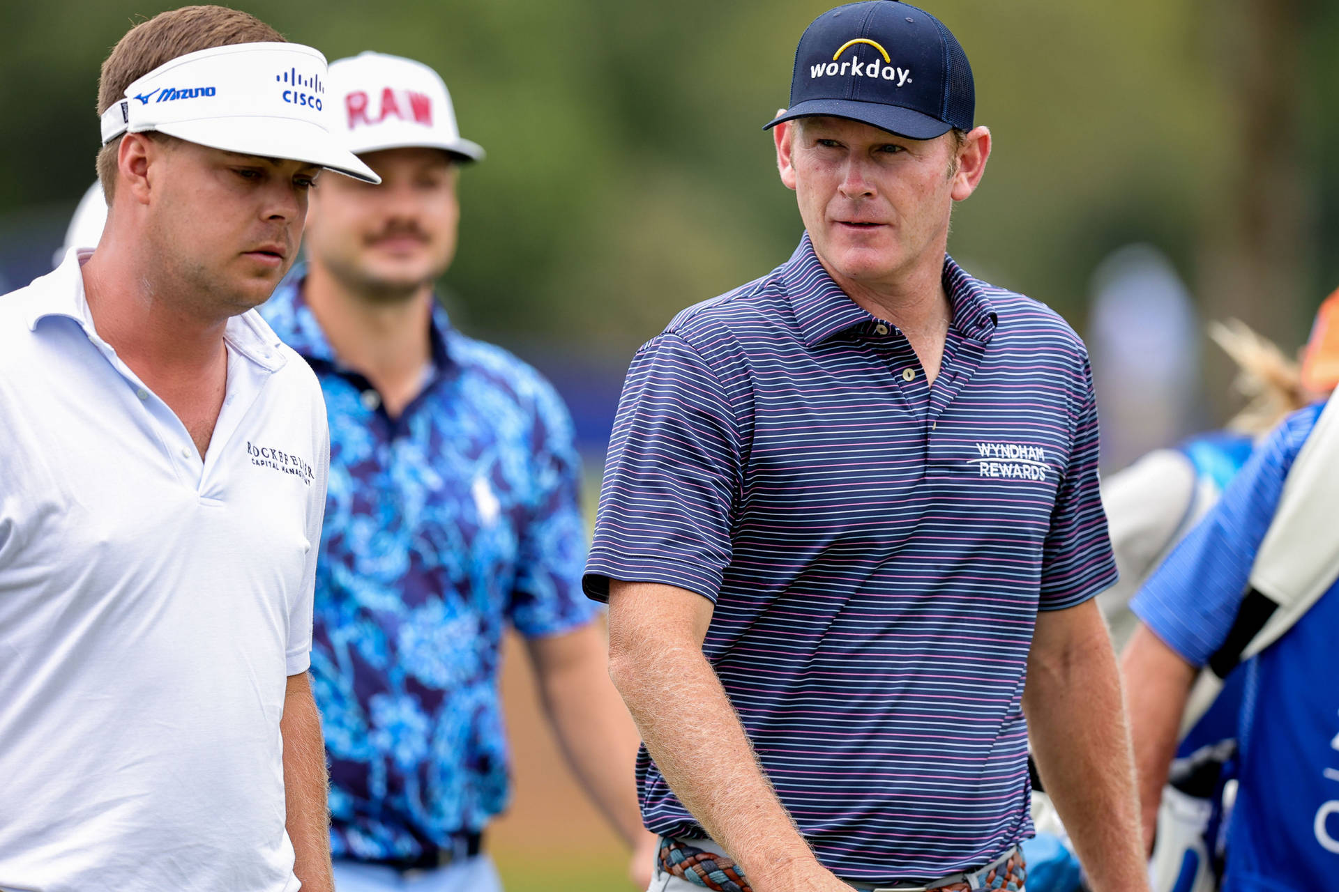 Professional Golfer Keith Mitchell With Fellow Golfers On The Course Background