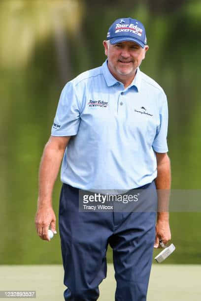 Professional Golfer, Ken Duke, Taking A Swing On The Golf Course. Background
