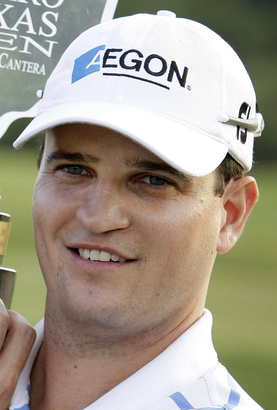 Professional Golfer Zach Johnson Showcasing His Elegant Poise While Wearing A White Cap Background