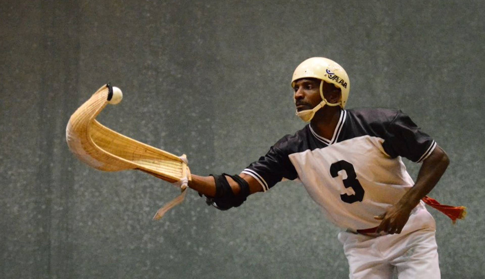 Professional Jai Alai Player In Action Background