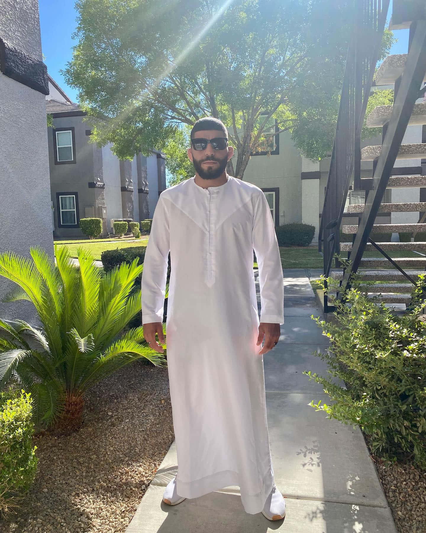 Professional Mma Fighter Amir Albazi In A Relaxed Pose At Home Background