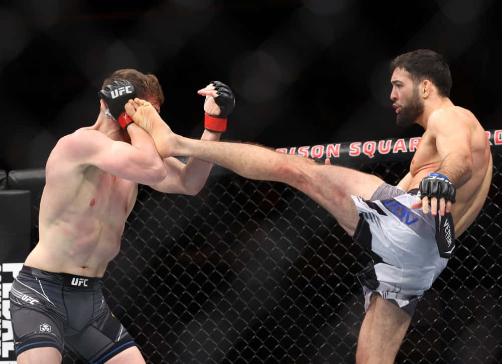 Professional Mma Fighter, Nassourdine Imavov, Skillfully Defending A Kick During A Match.