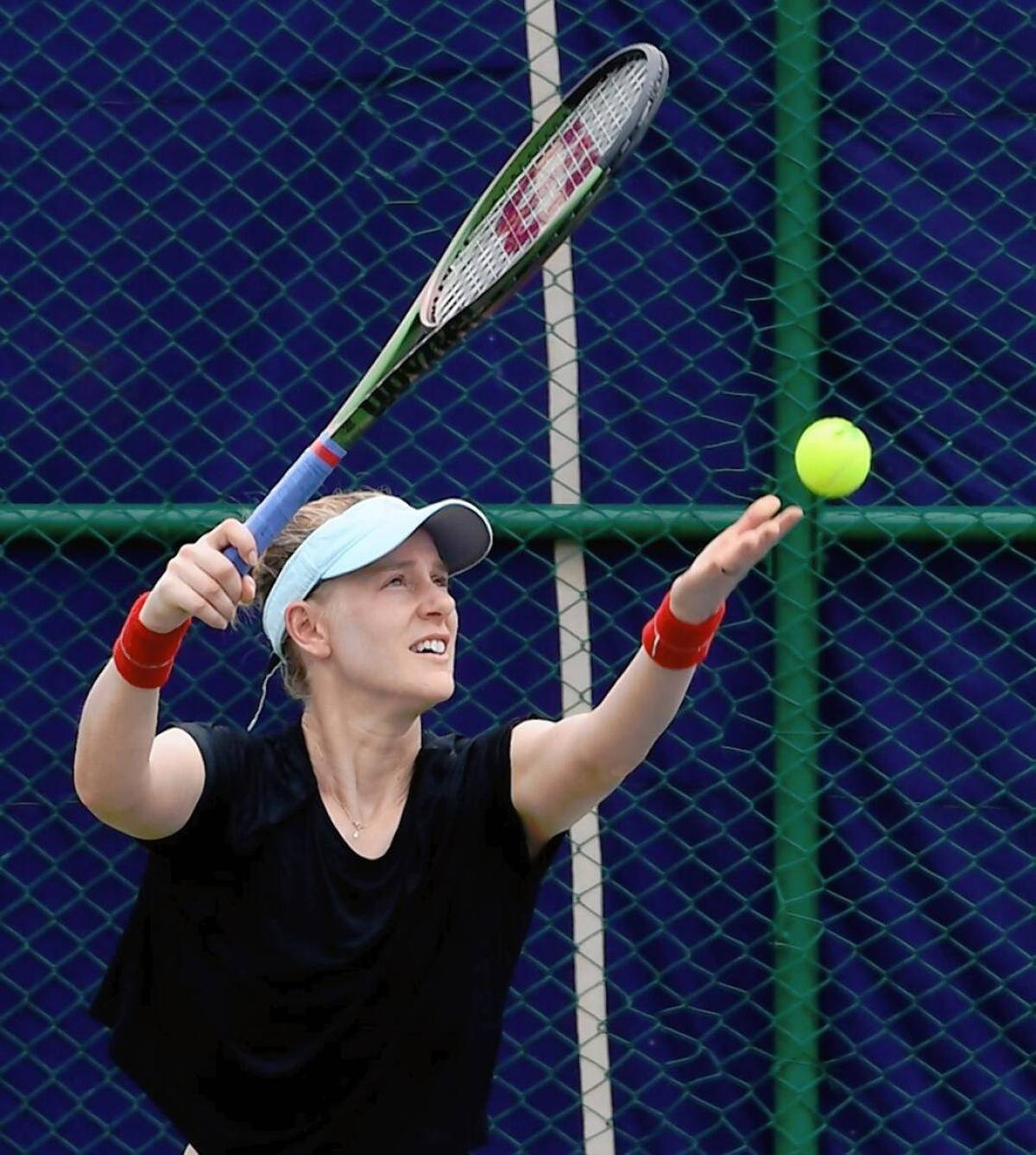 Professional Tennis Player Alison Riske-amritraj Performing A Service Background