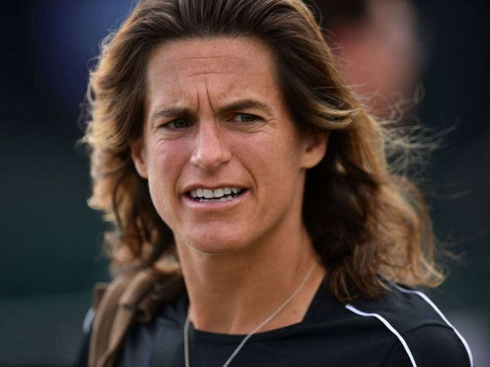 Professional Tennis Player Amélie Mauresmo Displaying Concern During A Match Background