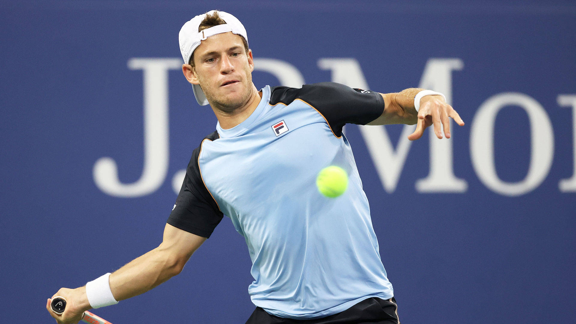 Professional Tennis Player Diego Schwartzman In Action, Skillfully Approaching The Ball. Background