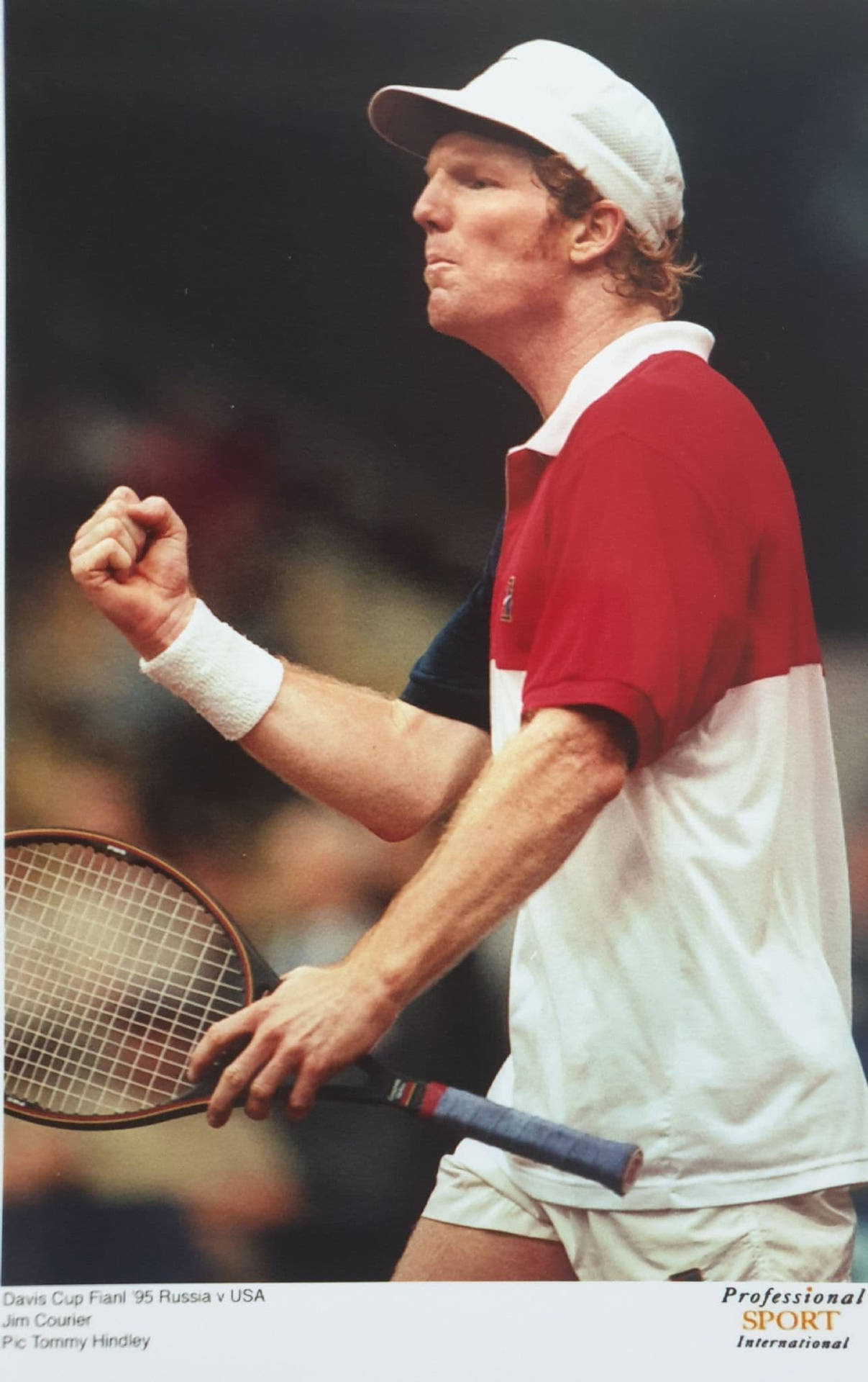 Professional Tennis Player Jim Courier In Action Background