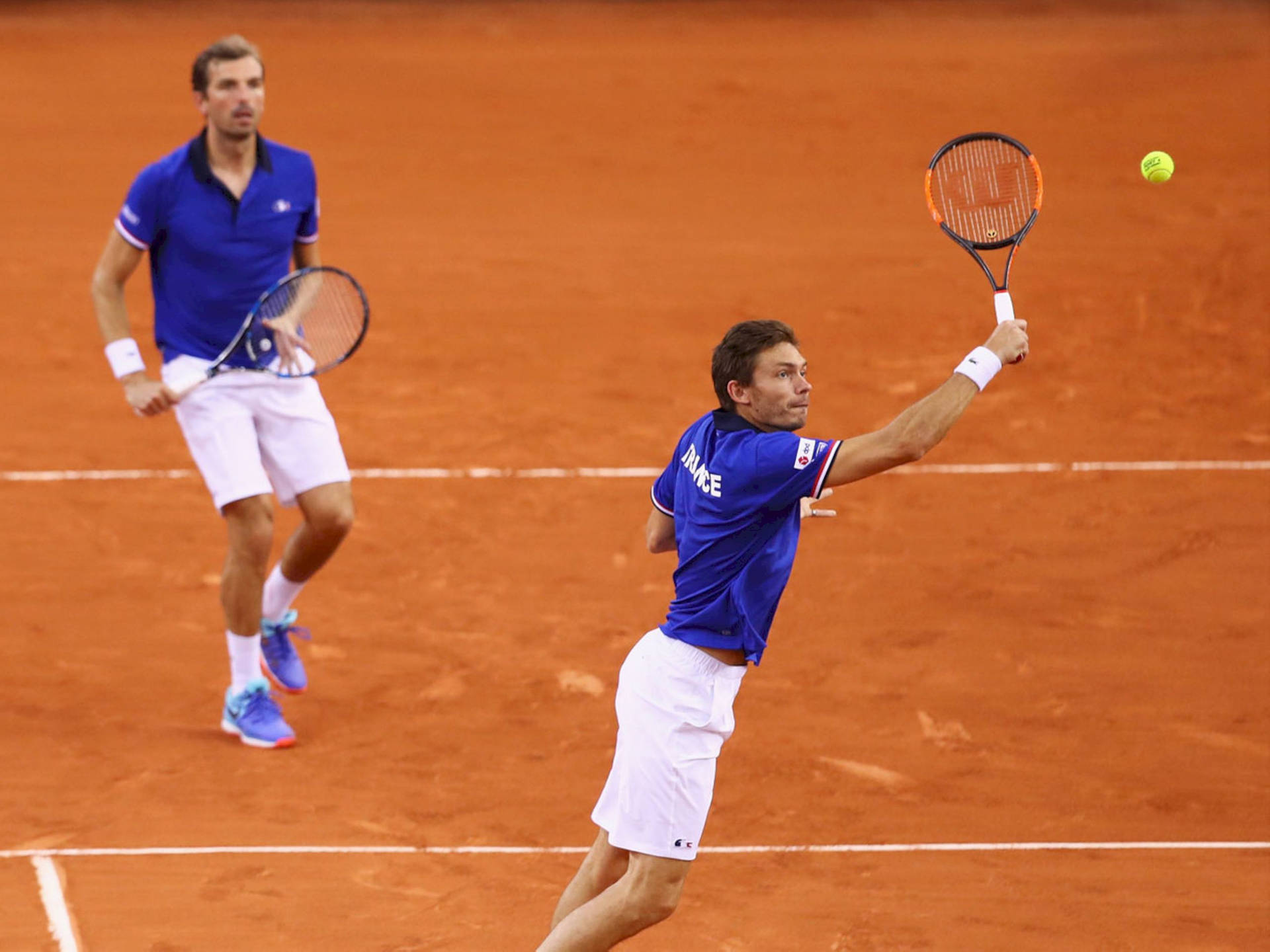 Professional Tennis Player Nicolas Mahut In Doubles Game Action Background