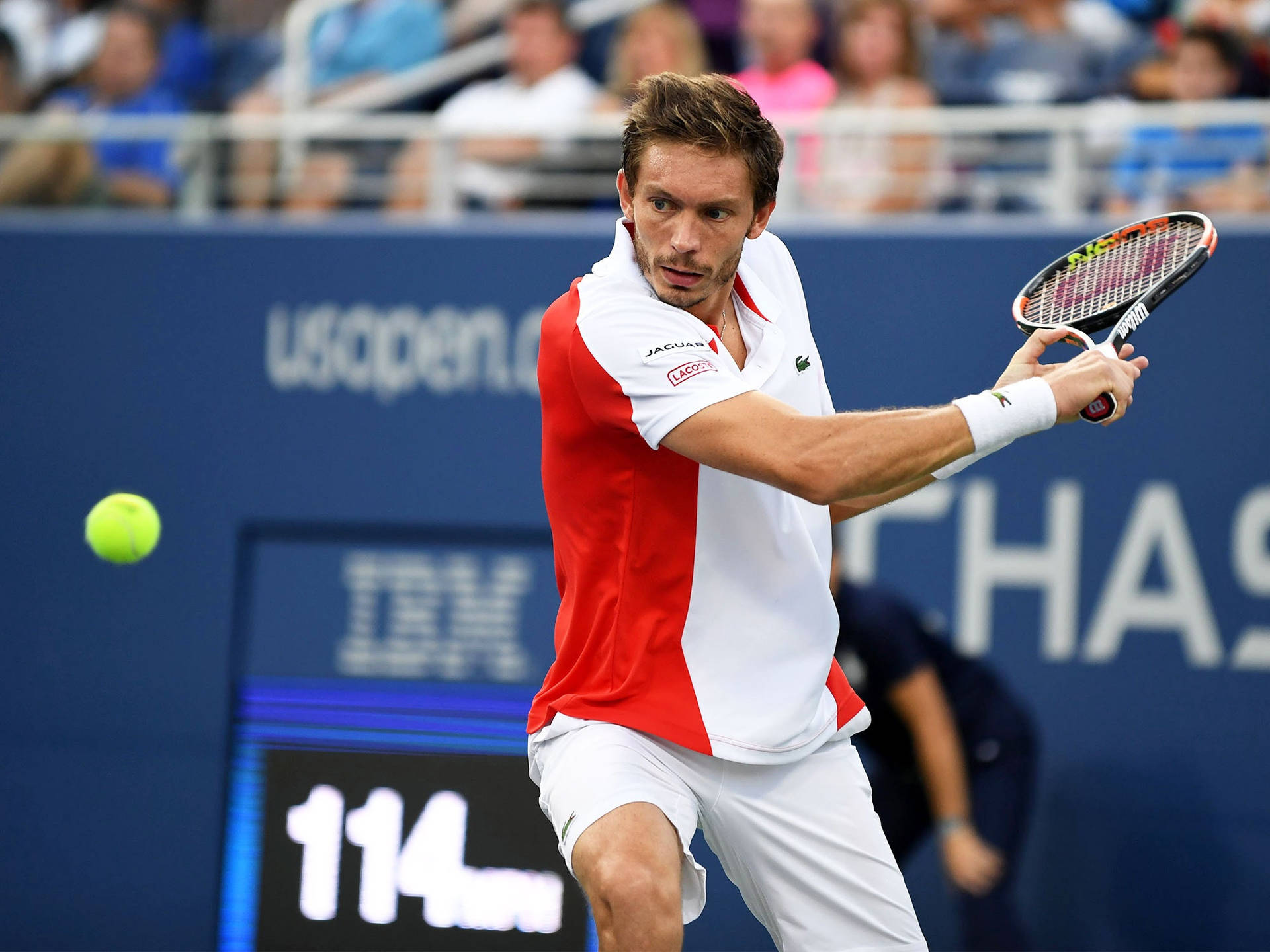 Professional Tennis Player Nicolas Mahut Intensely Focusing On The Ball During A Match. Background