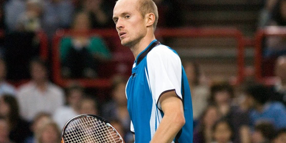 Professional Tennis Player Nikolay Davydenko Focused On Game Background