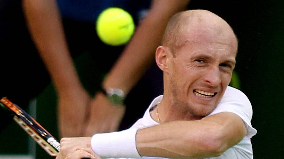 Professional Tennis Player Nikolay Davydenko Squinting In The Sun Background