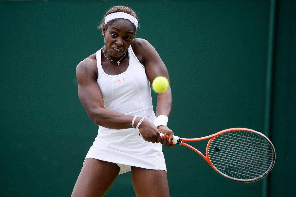 Professional Tennis Player, Sloane Stephens, In Action With Both Hands On Racket Background
