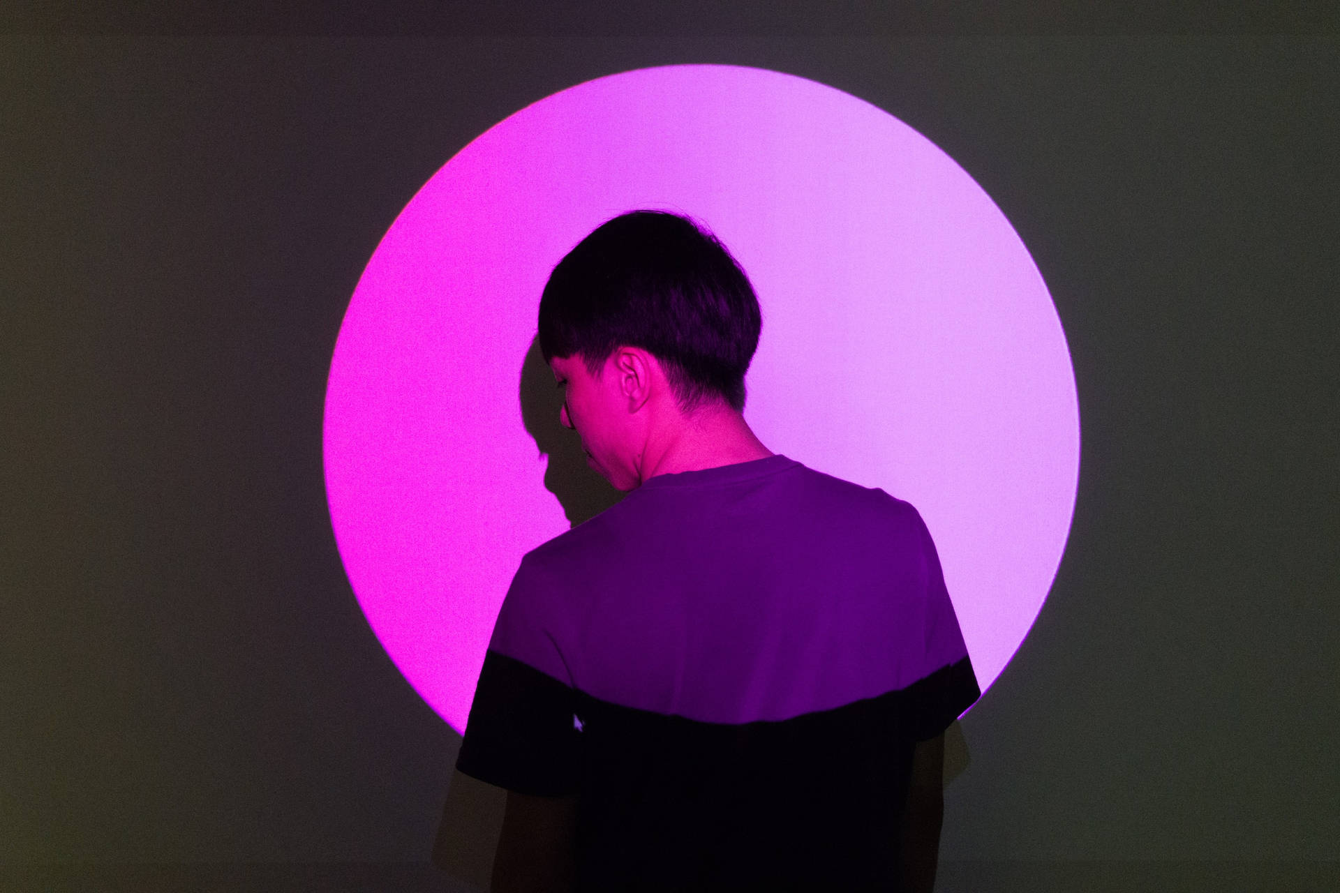 Profile Of A Man In Pink Spotlight Background