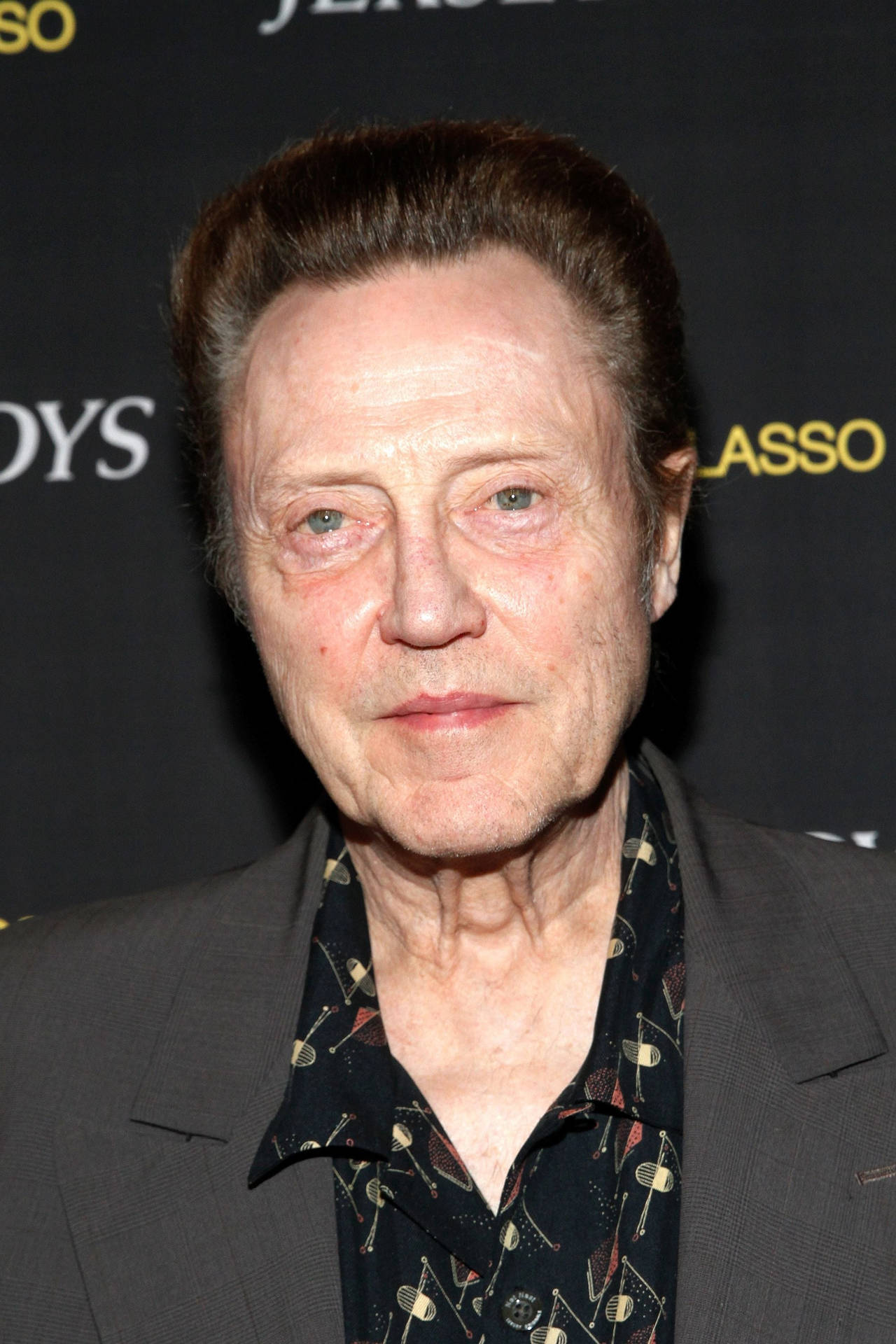 Prolific And Versatile Actor Christopher Walken In A Suit. Background