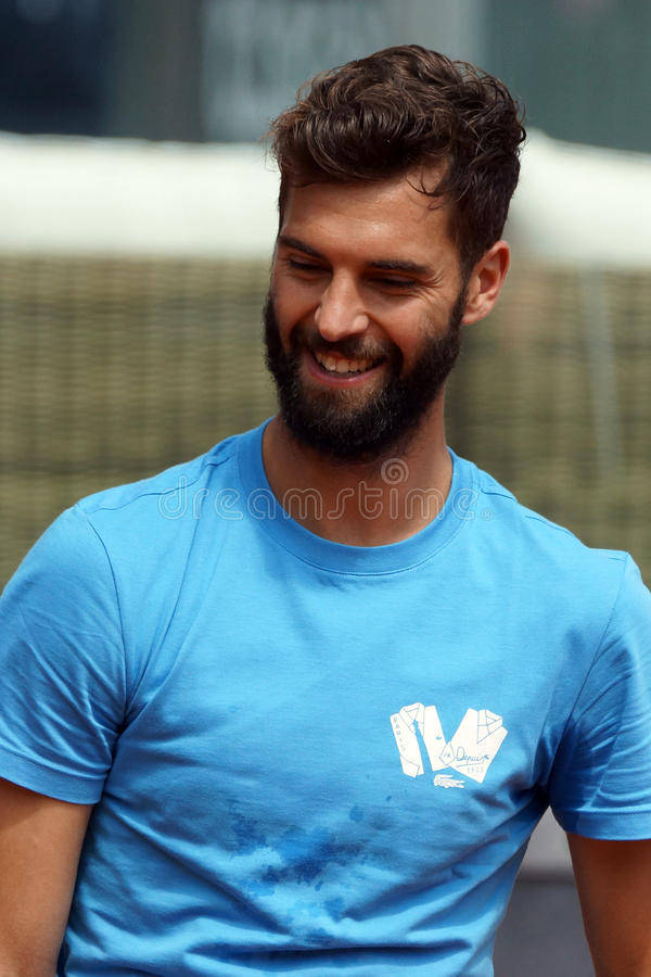 Prolific Tennis Player, Benoit Paire Flashes A Smiling Profile Background