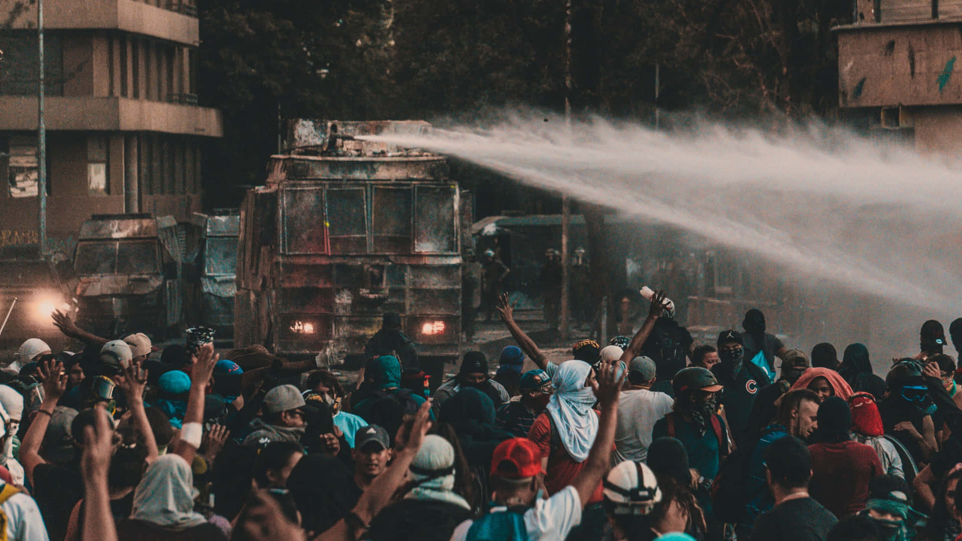 Protesters_ Facing_ Water_ Cannon Background