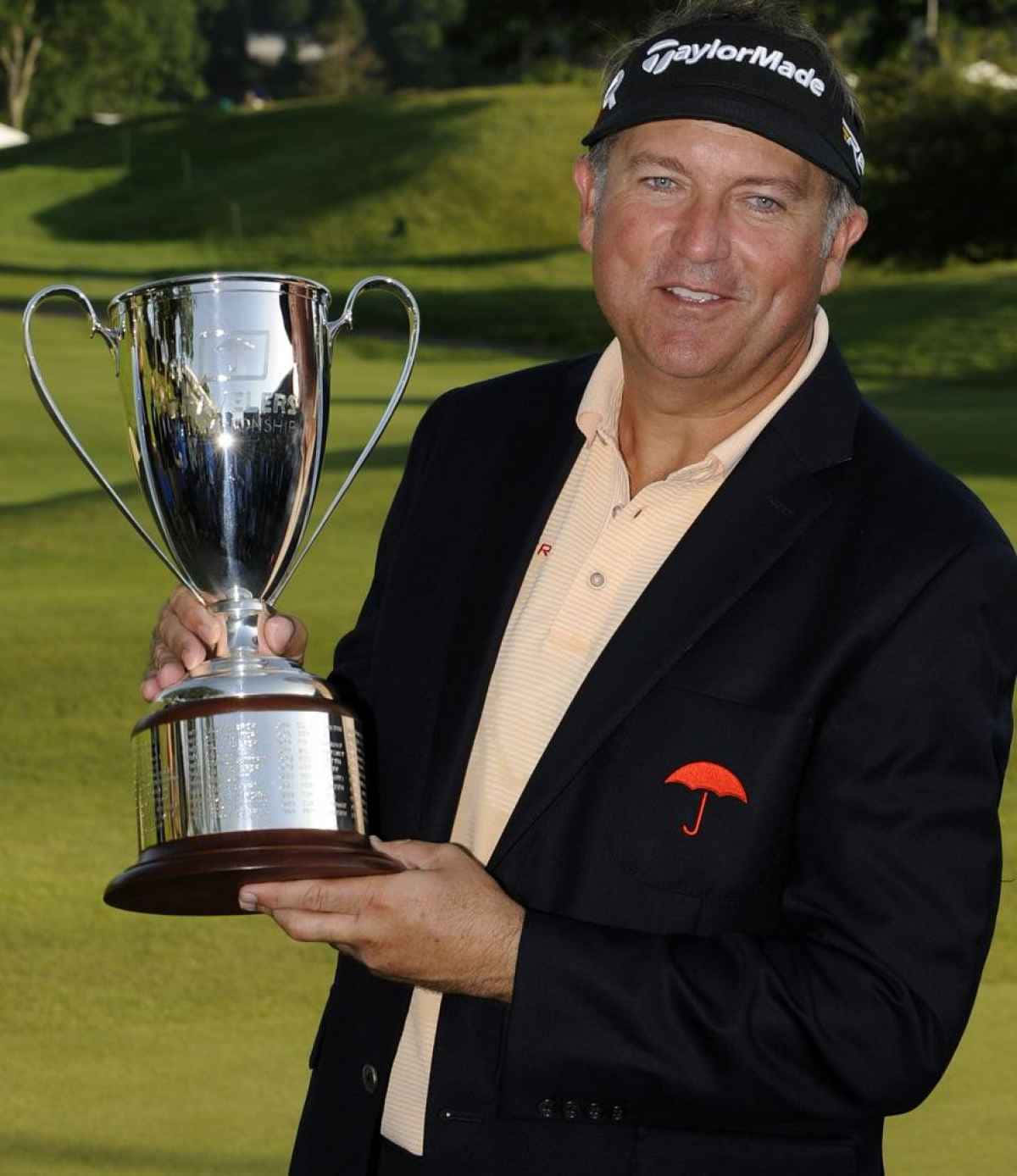 Proud Ken Duke Holding The Trophy He Recently Won. Background