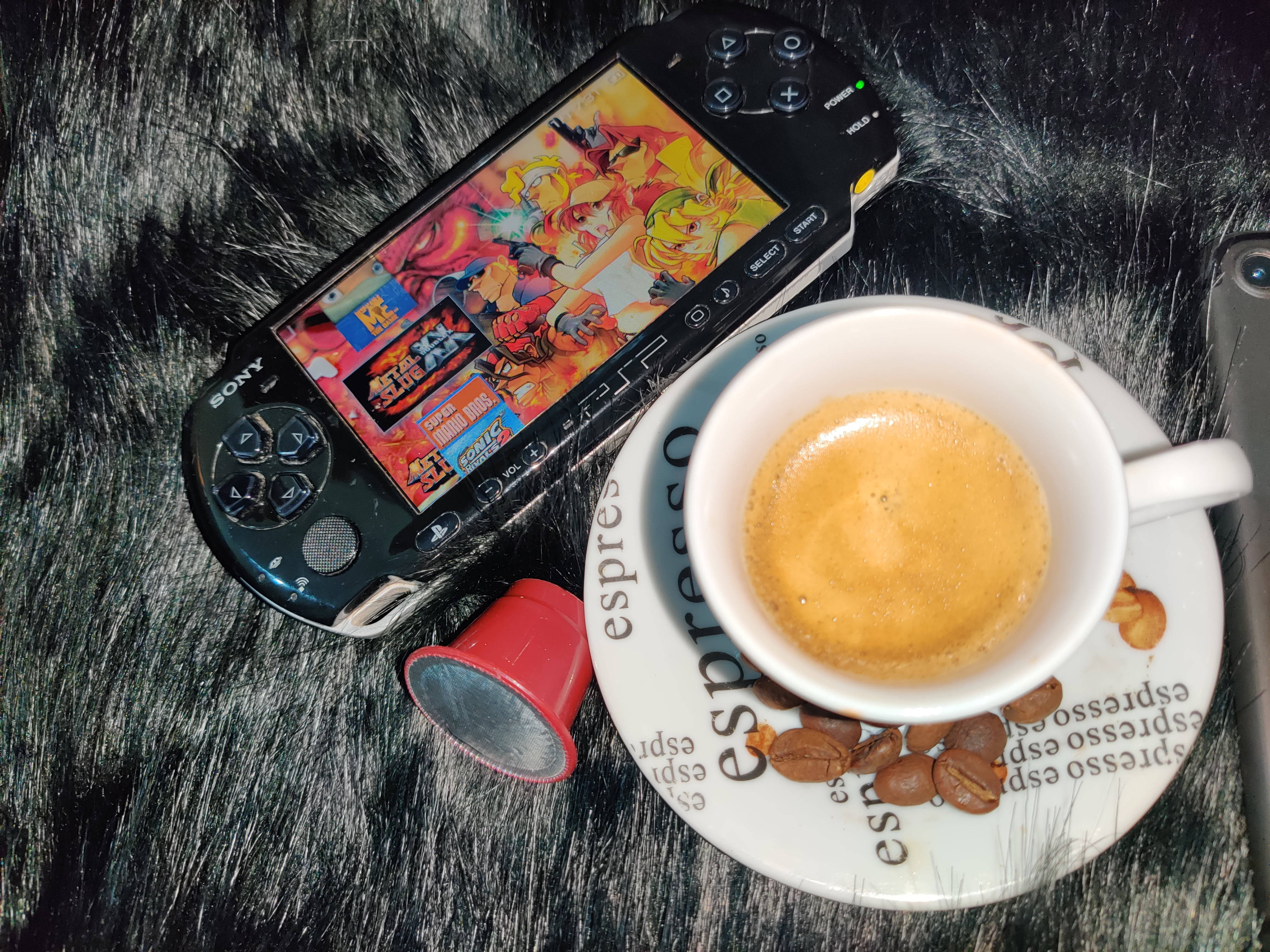 Psp With Coffee Cup On Fluffy Surface Background
