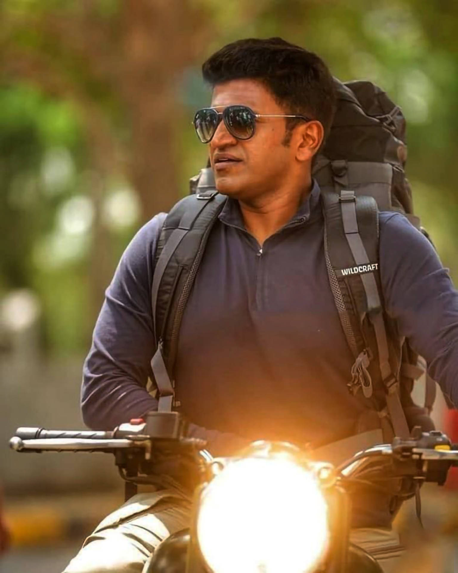 Puneeth Rajkumar Riding Motorcycle Background