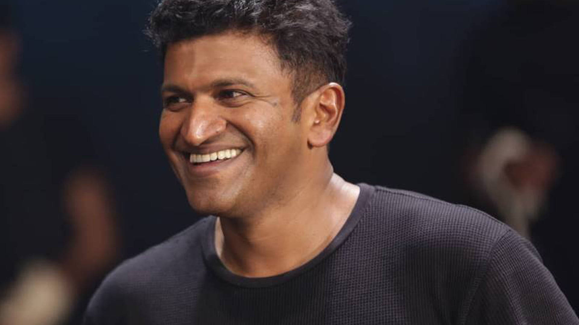 Puneeth Rajkumar Smiling Background