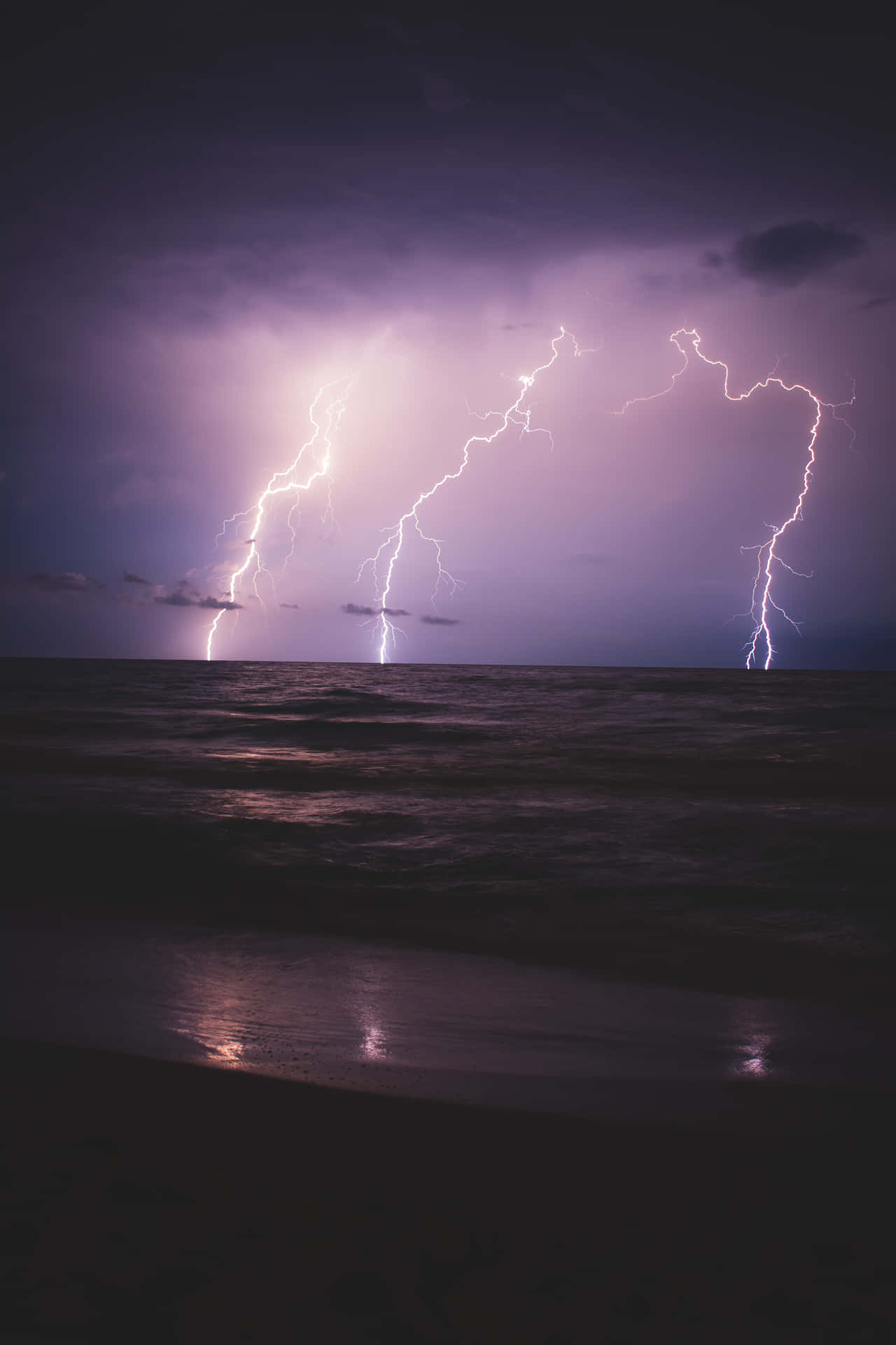 Purple Lightning Above Waves Background