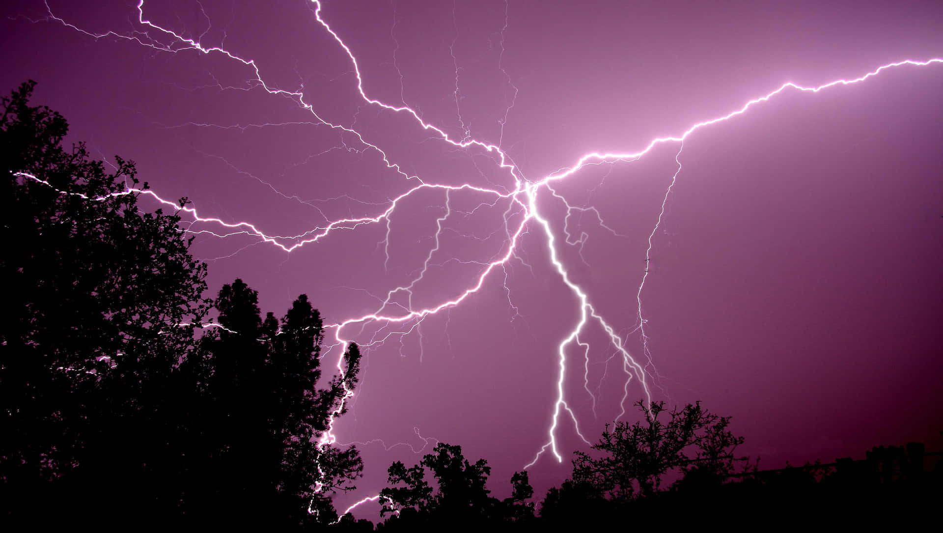 Purple Lightning Bolts Flashing In Sky Background