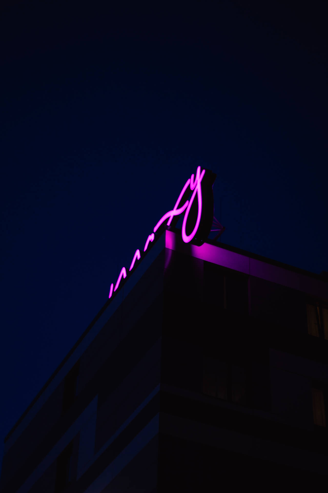 Purple Neon Sign On Roof Background