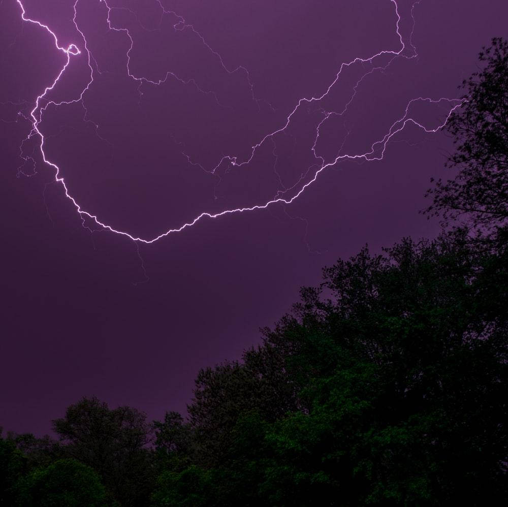 Purple Thunderstorm Over Trees Background