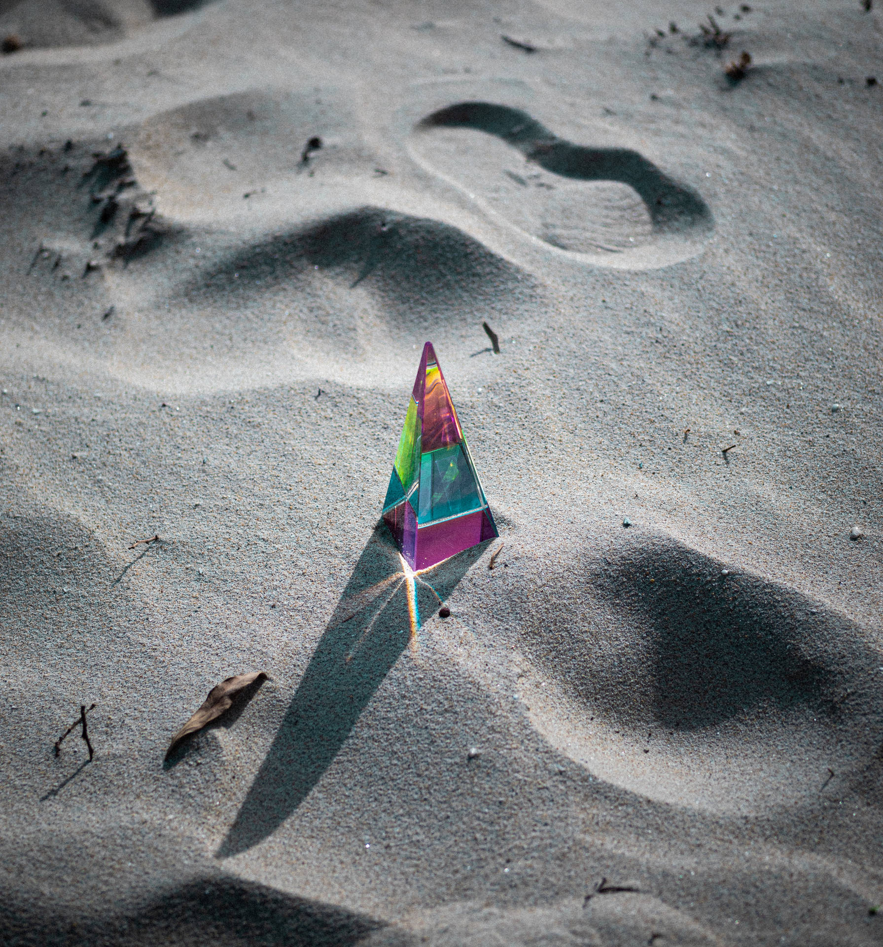 Pyramid Rainbow Prism On Sand Background