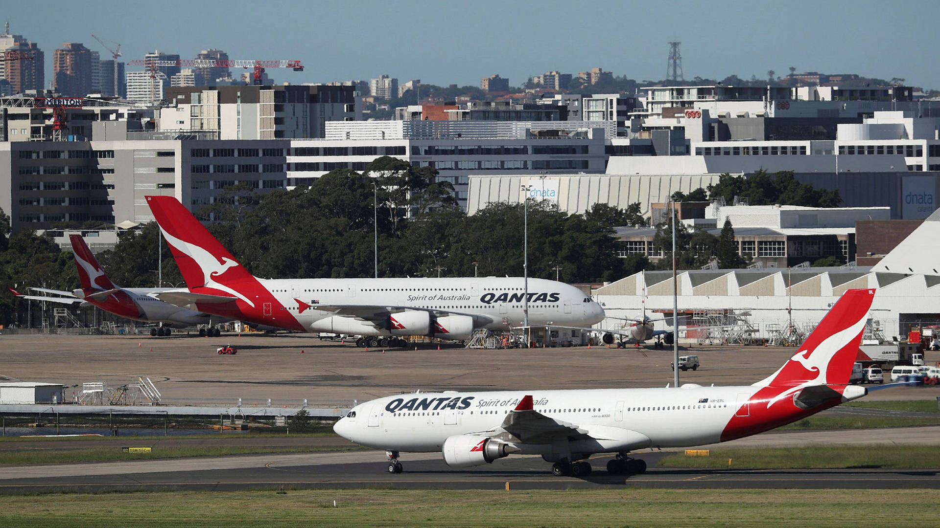 Qantas Airbuses At The Busy Airport Background