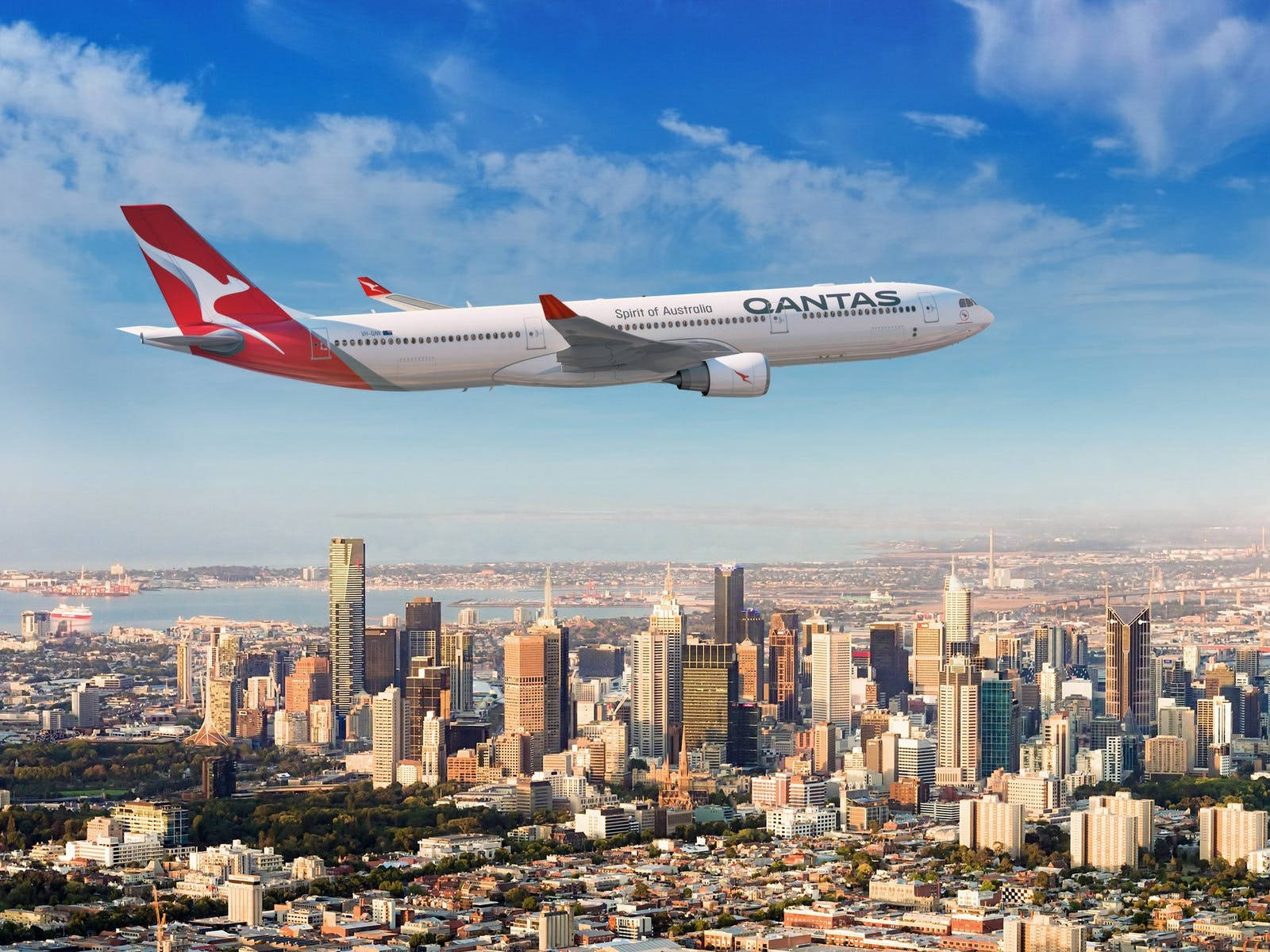 Qantas Passenger Airplane Over The City Background