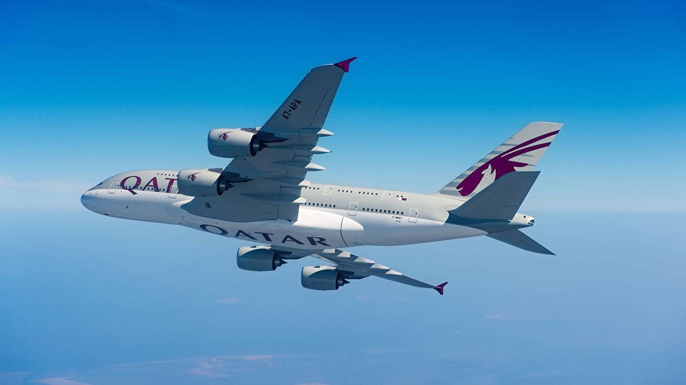 Qatar Airways Plane Splitting The Blue Sky Background