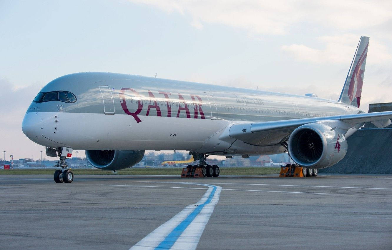 Qatar Airways Taxiing On The Runway Background