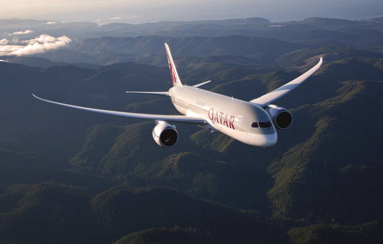 Qatar Airways Up In The Air With A Scenic View Background