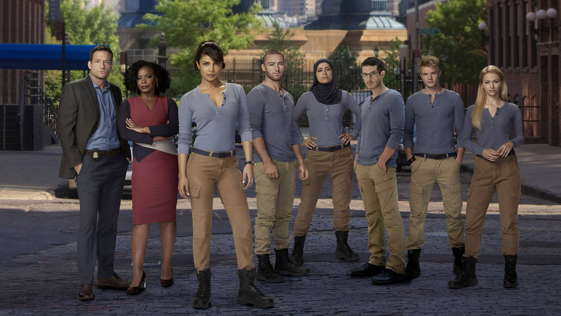 Quantico Tv Series Characters Posing In The Foreground Of Fbi Academy