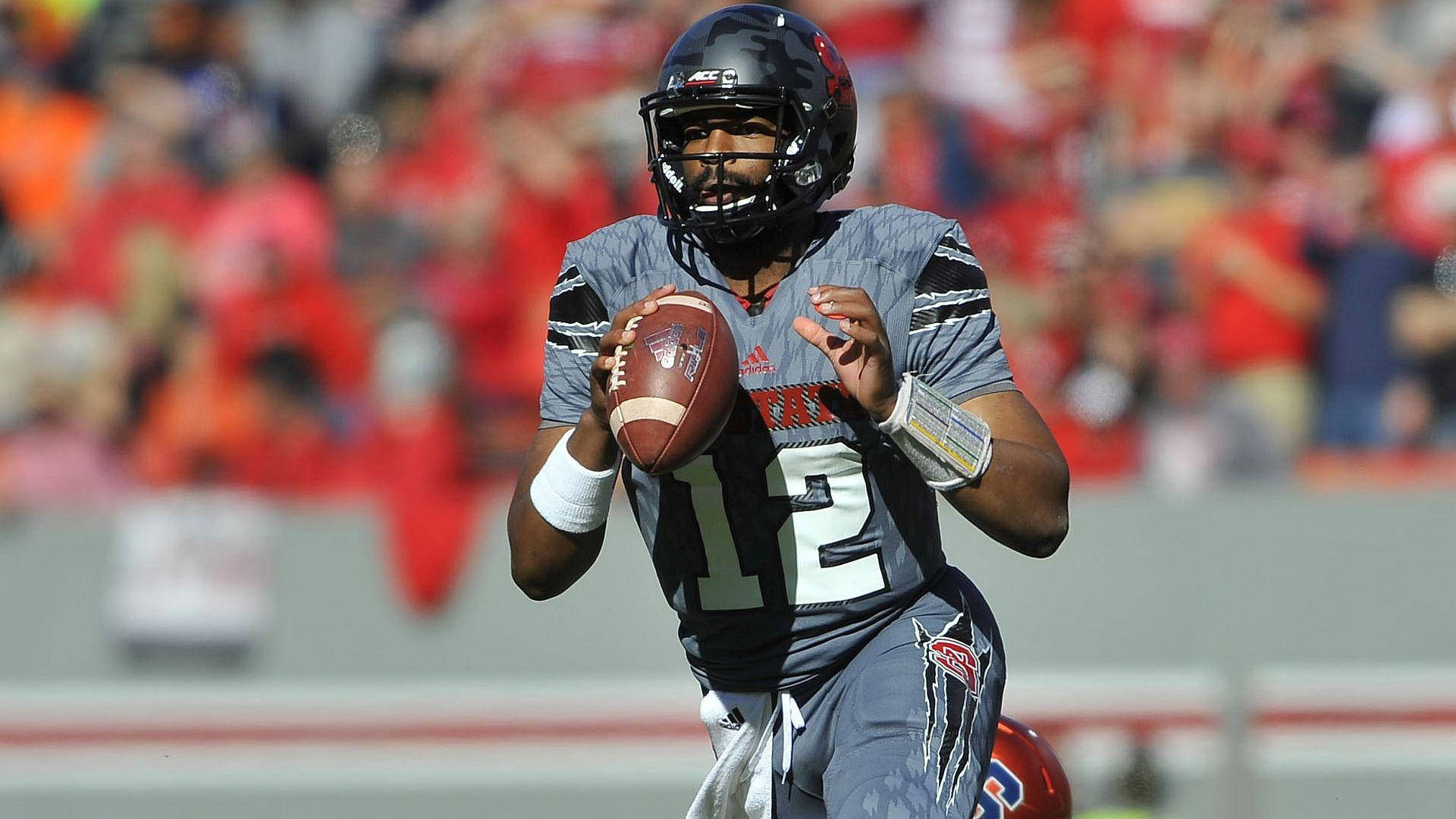 Quarterback Jacoby Brissett Spotlight - On Field In Grey Uniform Background