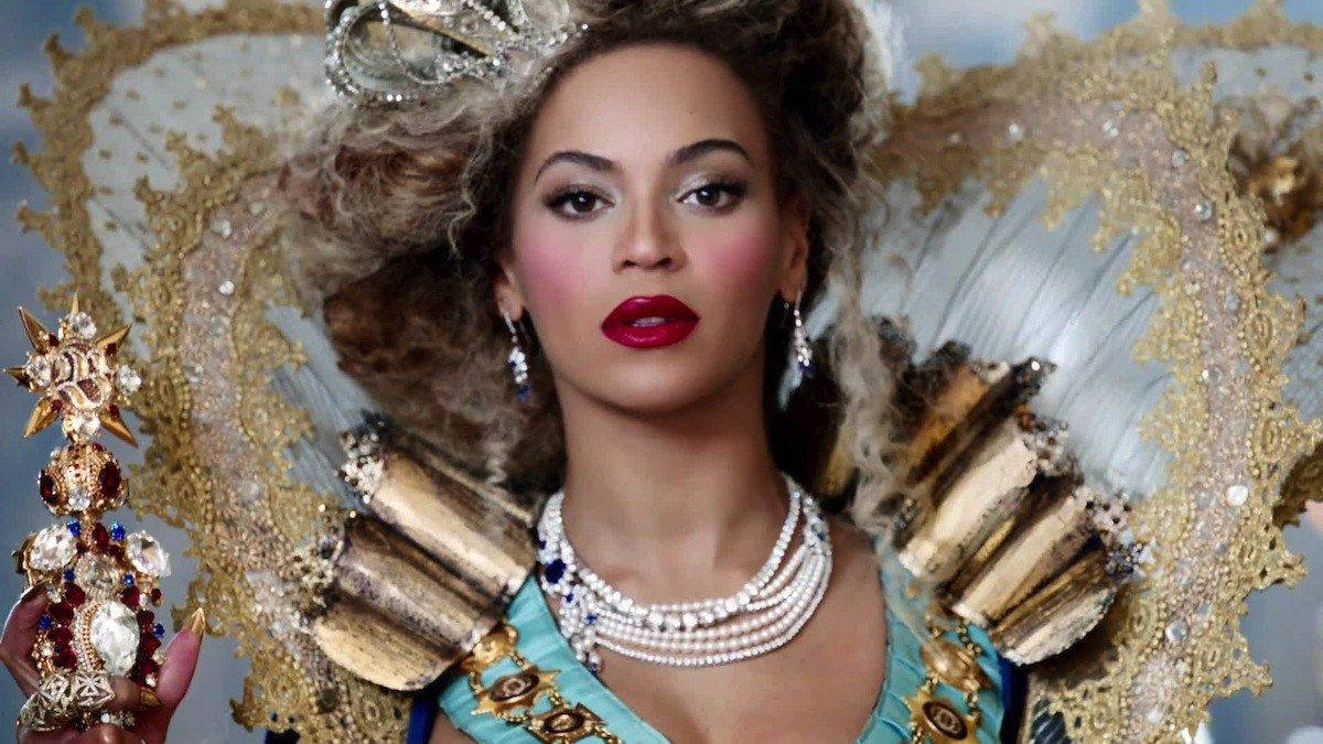 Queen Of Pop Music: Beyonce Wearing A Regal Costume Background
