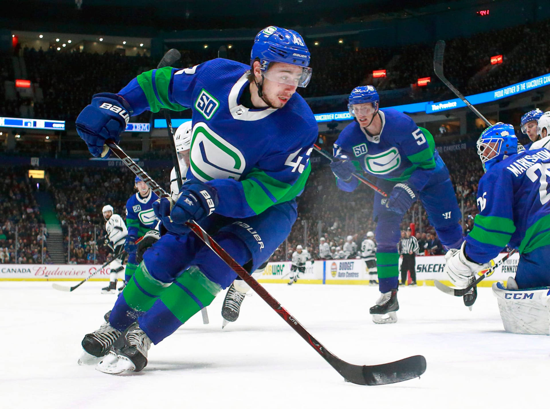 Quinn Hughes In Action During A Hockey Game Background