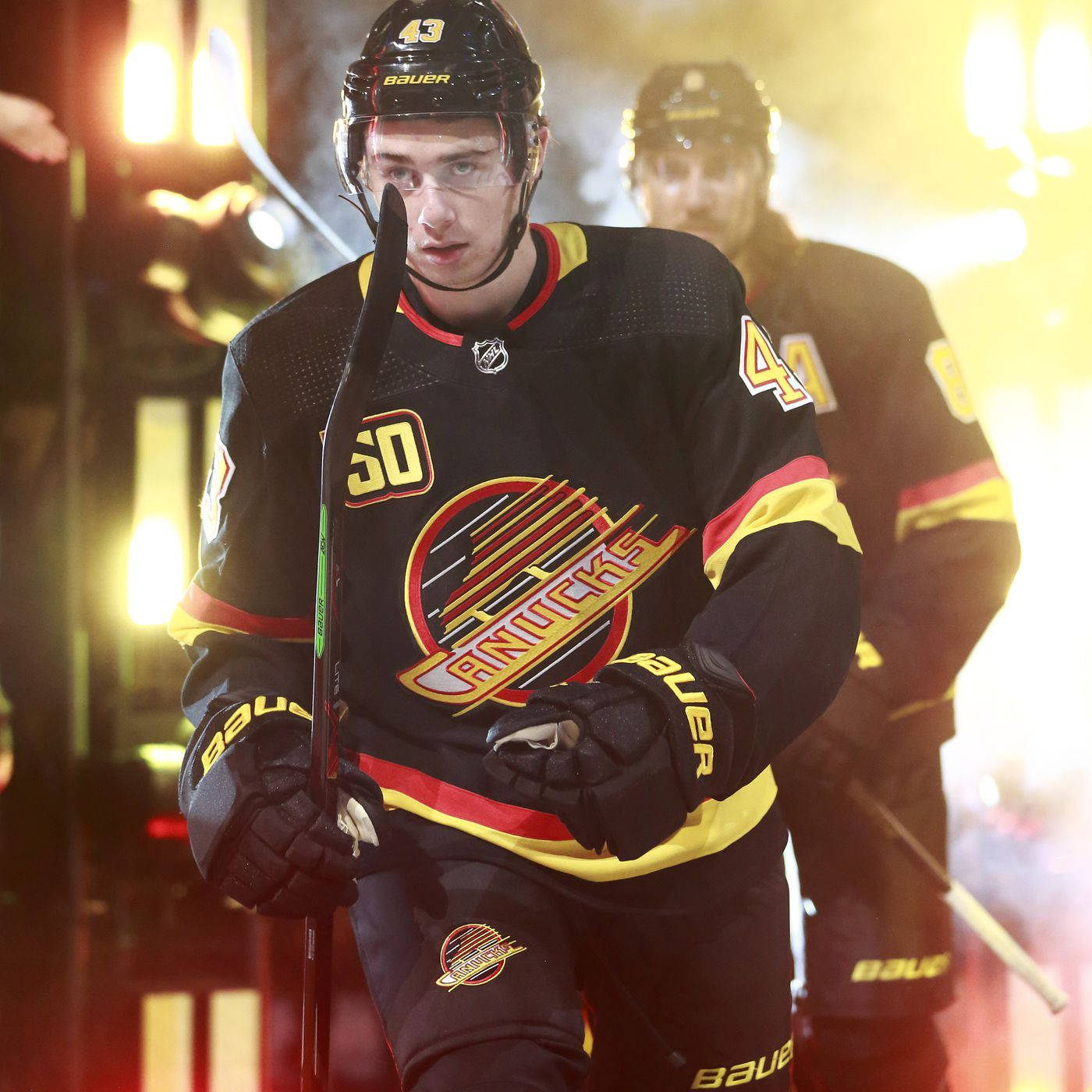 Quinn Hughes In Retro Black Jersey During Game Opening Background