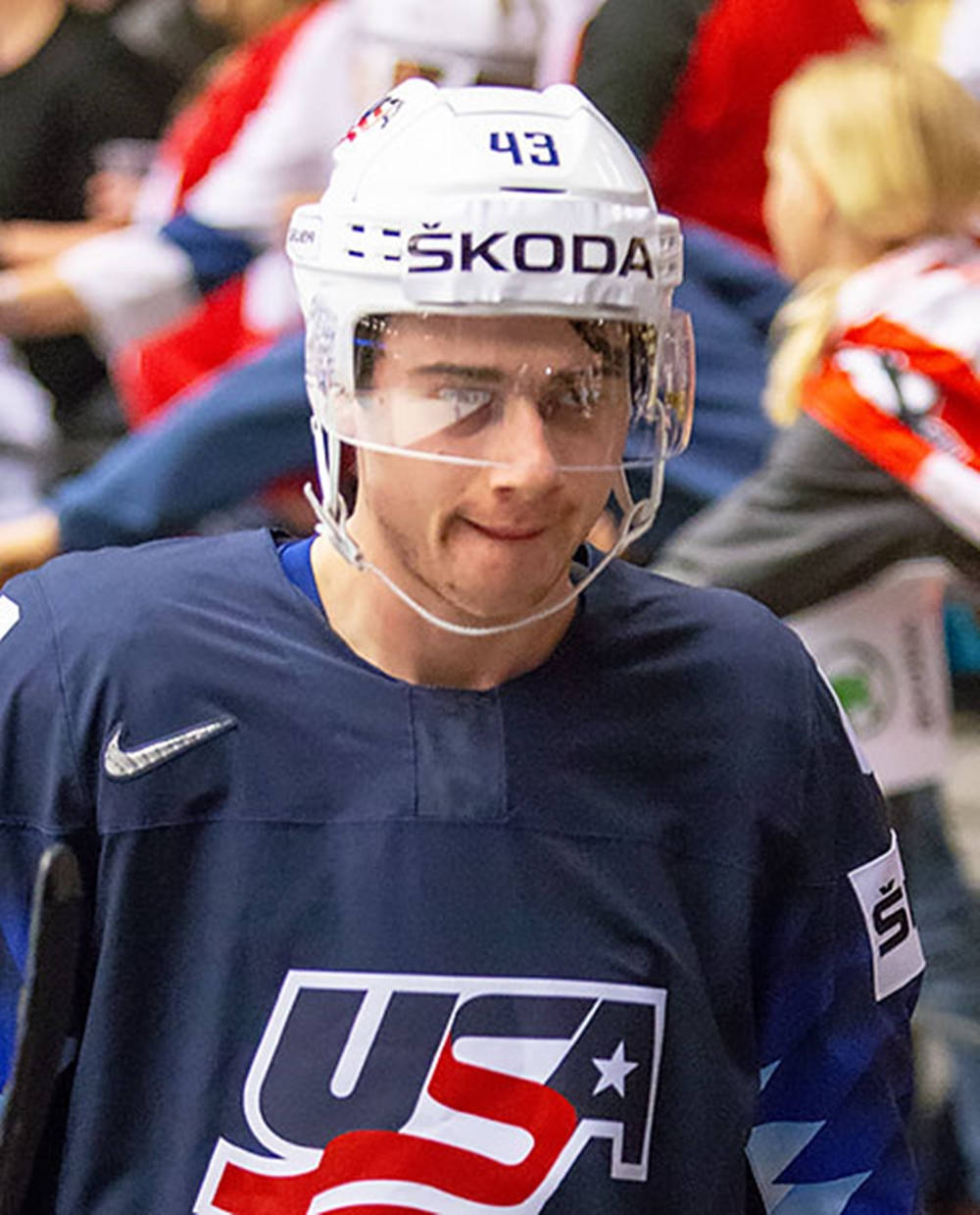 Quinn Hughes Wearing Skoda Helment And Biting Lips Background