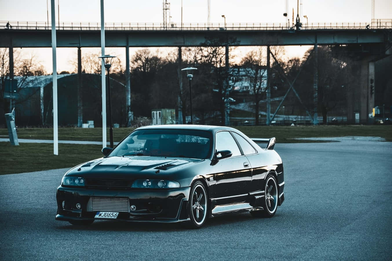 R33 Gtr Black Lowrise Driving On The Road Background