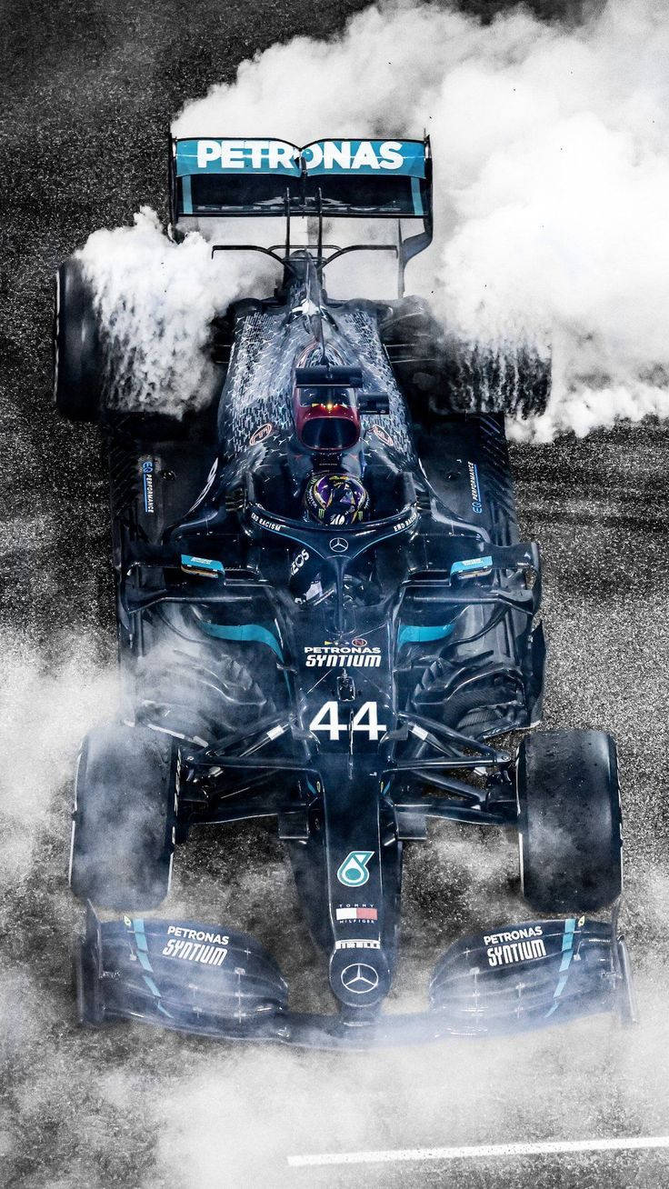 Racing Car Of Lewis Hamilton F1 With Smoke Background