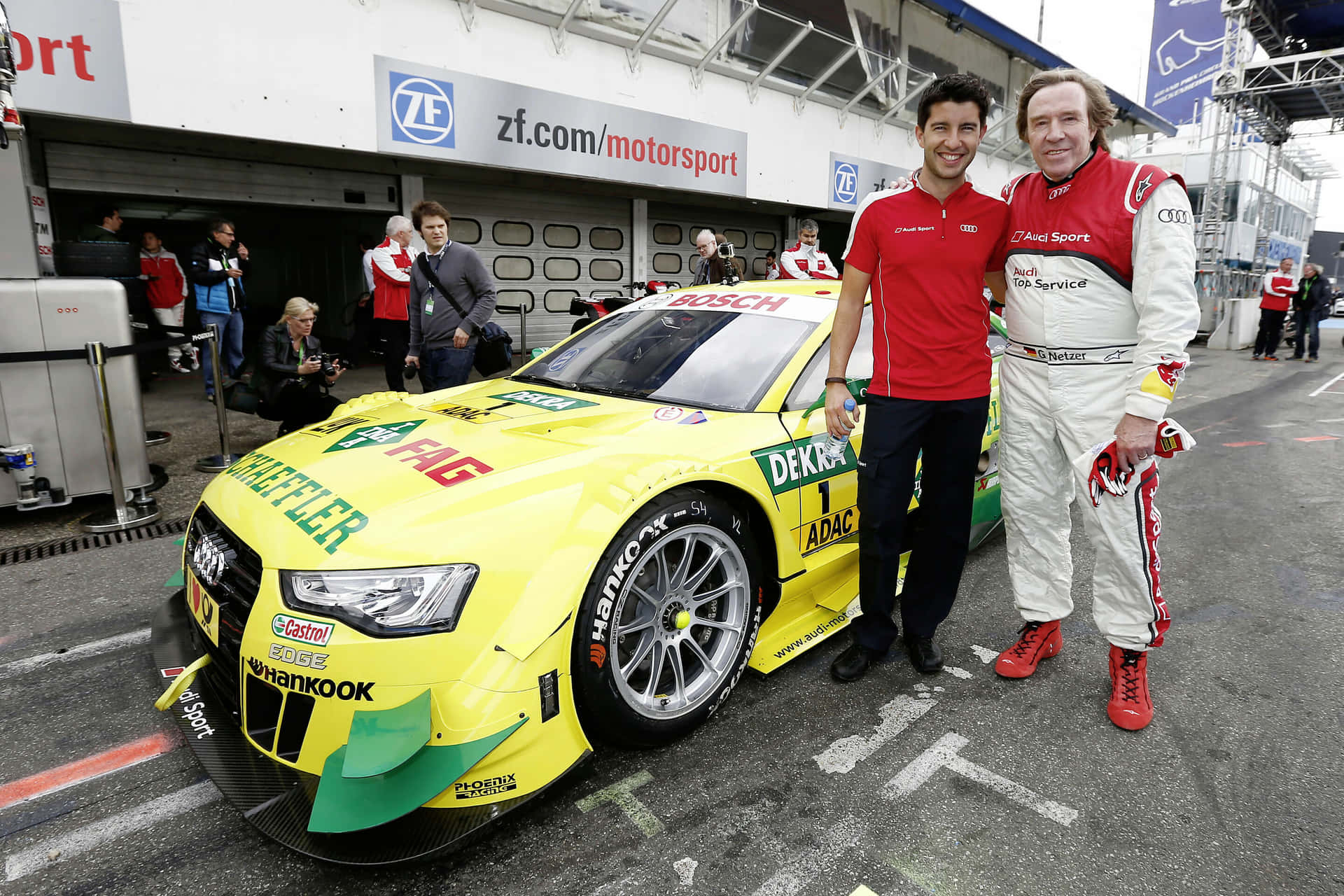Racing Team Beside Audi D T M Car Background