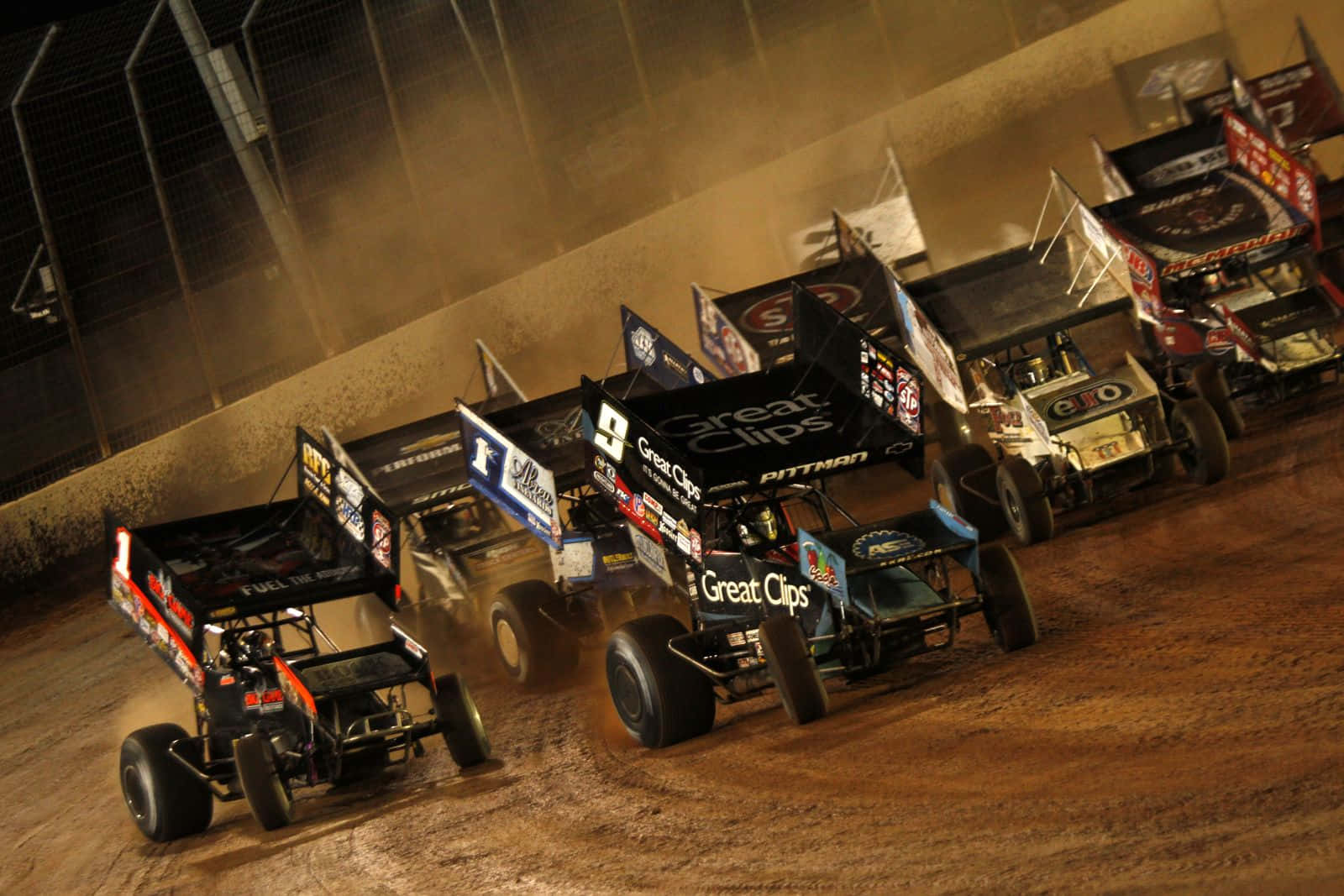 Racing The Dirt Track In A Sprint Car Background