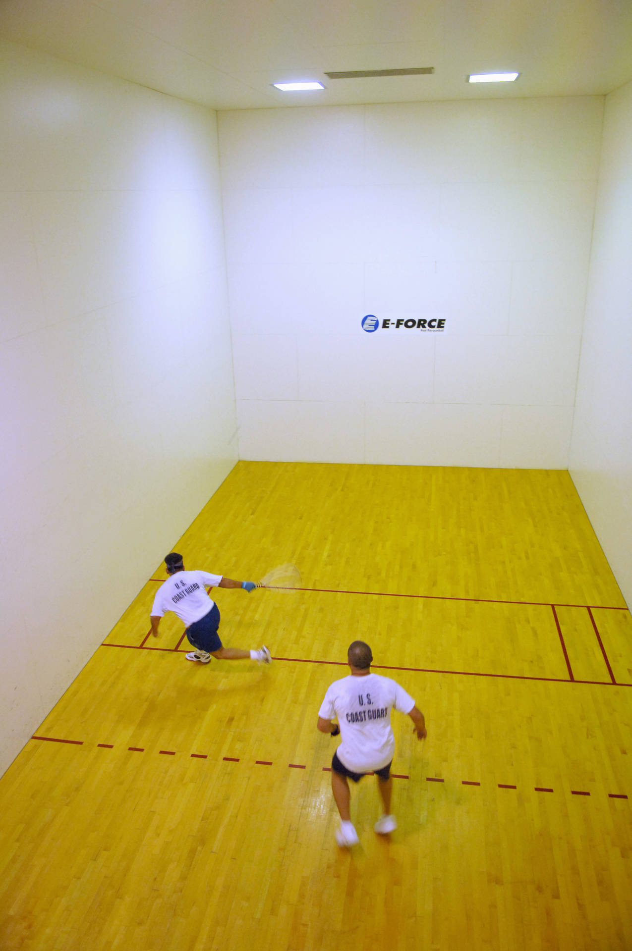 Racquetball Play Of Two Players Background