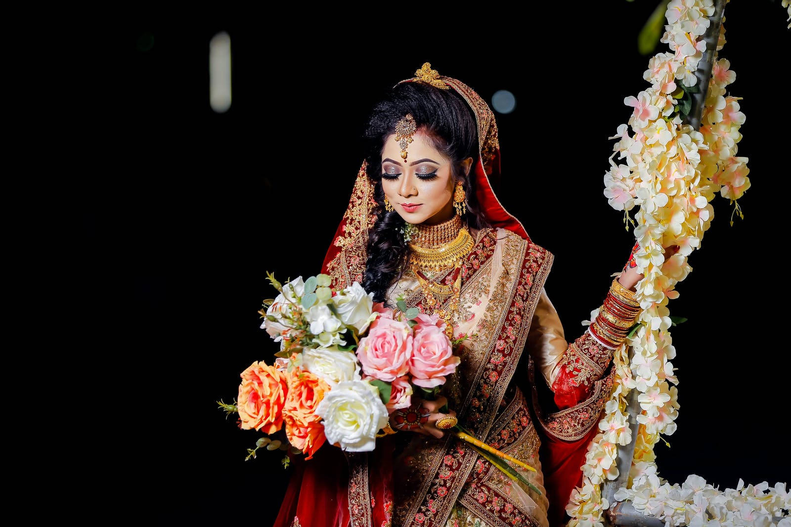 Radiant Indian Bride Holding A Bouquet At Her Wedding Background