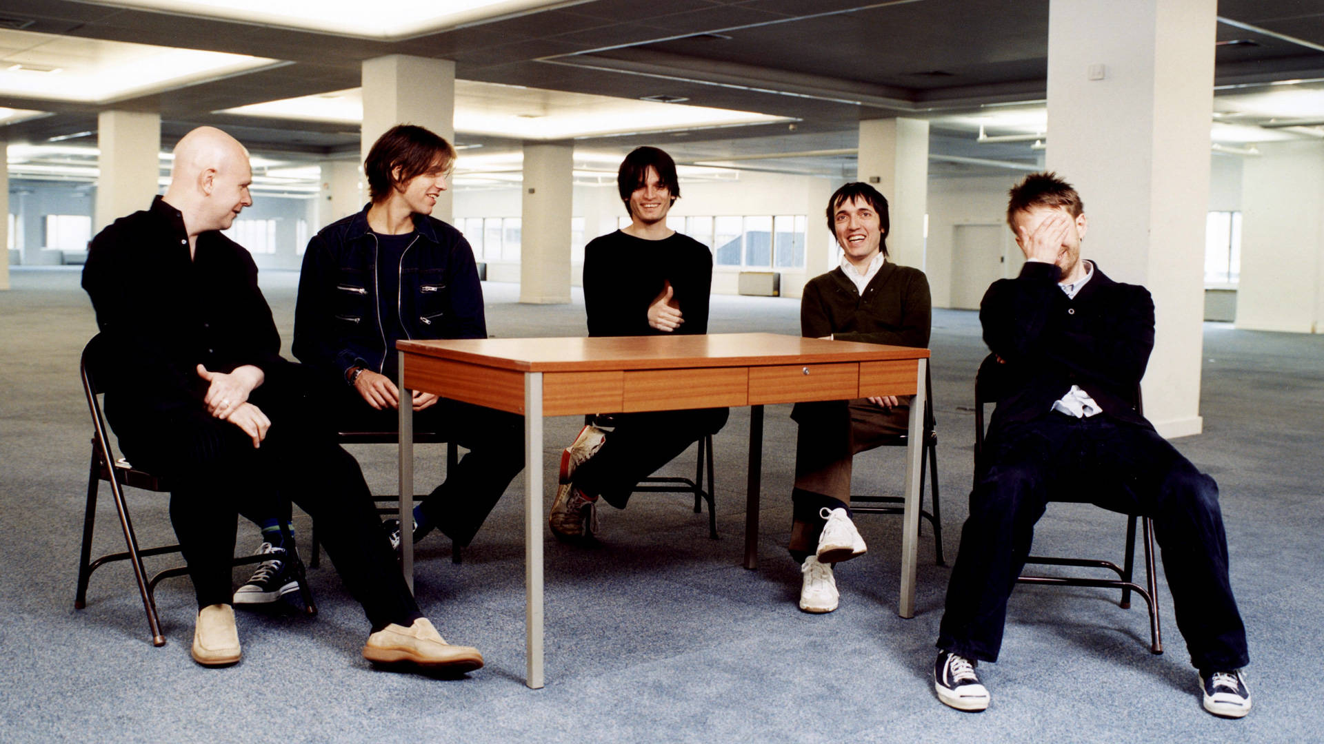 Radiohead Laughing Around A Table Background