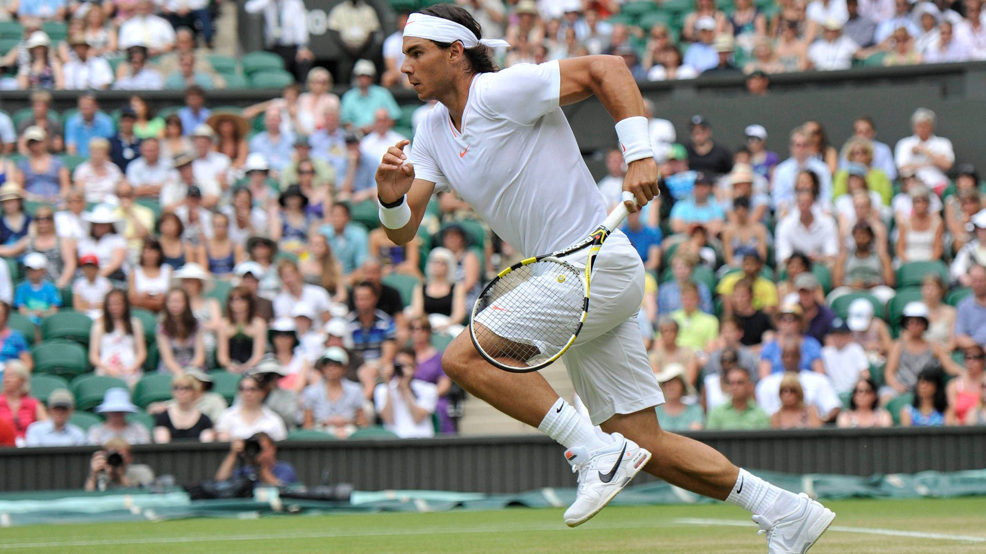 Rafael Nadal Running Across Field Background