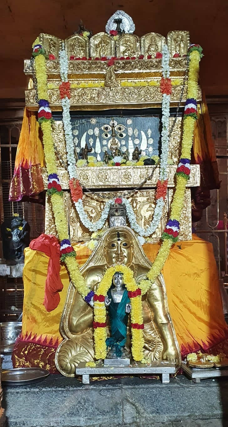Raghavendra And Krishna Statues With Garlands Background