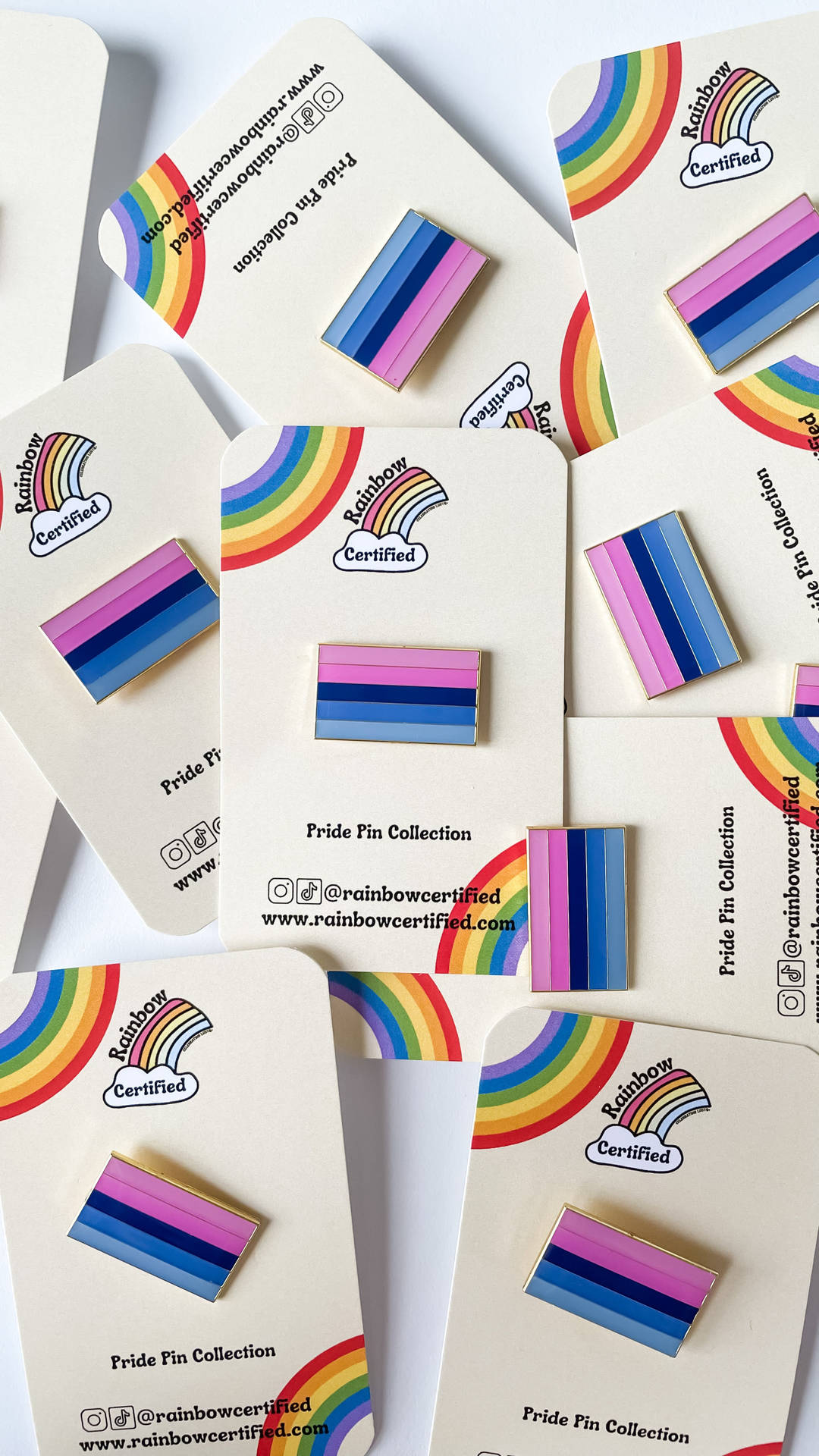 Rainbow Pins With A Rainbow Colored Stripe Background