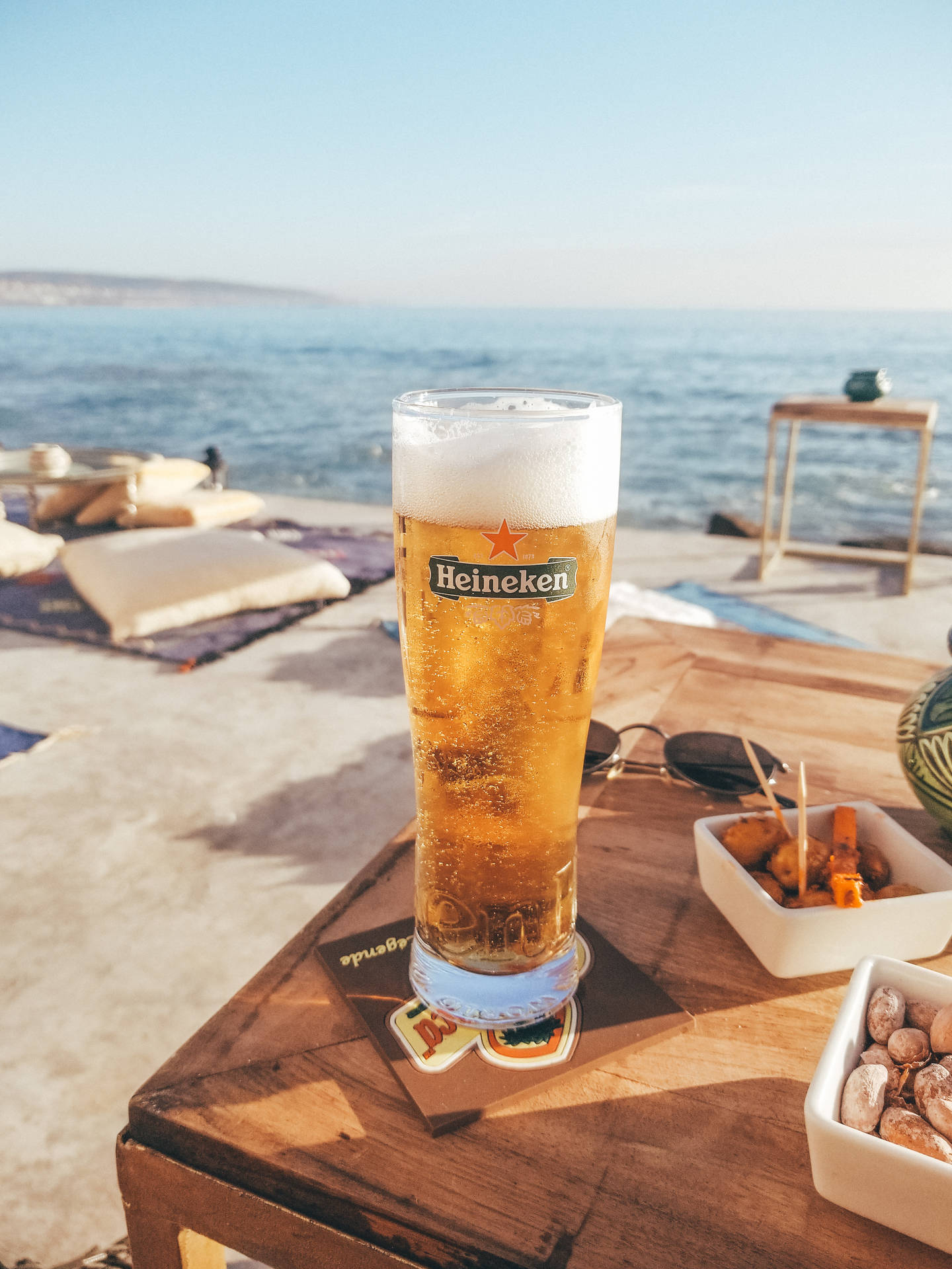 Raise A Glass Of Heineken Beer With Friends And Make It A Night To Remember Background